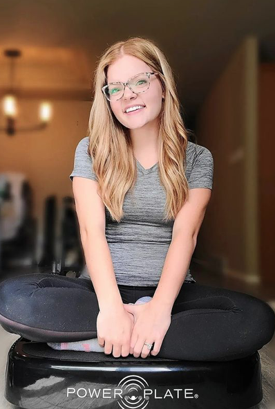 Brianna sitting on Power Plate